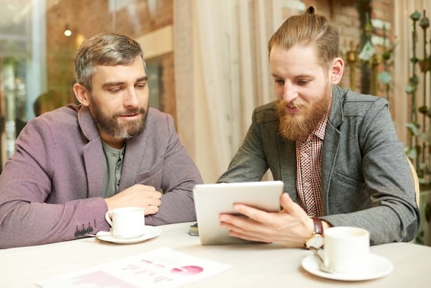 Two micro-influencers in a café, reviewing a brand partnership proposal on a tablet. They are discussing the details and planning their content strategy, emphasizing the importance of professional collaboration and strategic planning for successful campaigns.