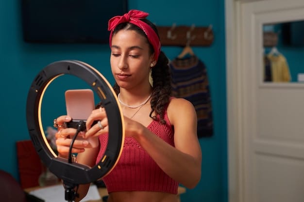 A close-up shot of a person creating a TikTok video on their phone, with an elaborate set up involving a ring light, microphone kit, and script notes beside a textbook, to show serious content production for education on TikTok.