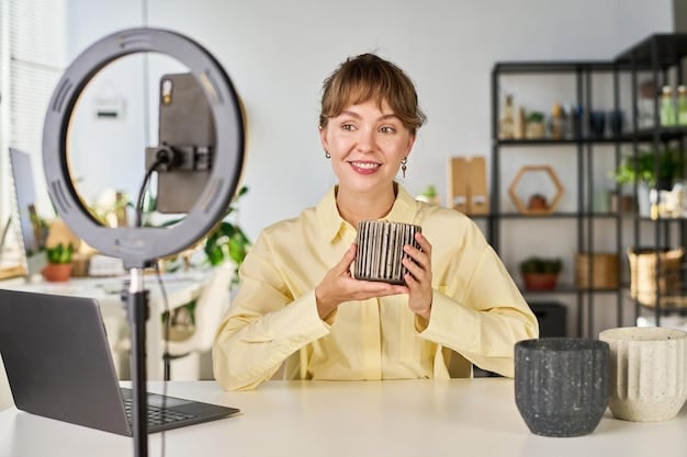 A photograph of an influencer sitting at a desk, looking directly at the camera with a sincere expression. The background is a blurred office setting, suggesting the influencer is preparing or delivering a public statement.